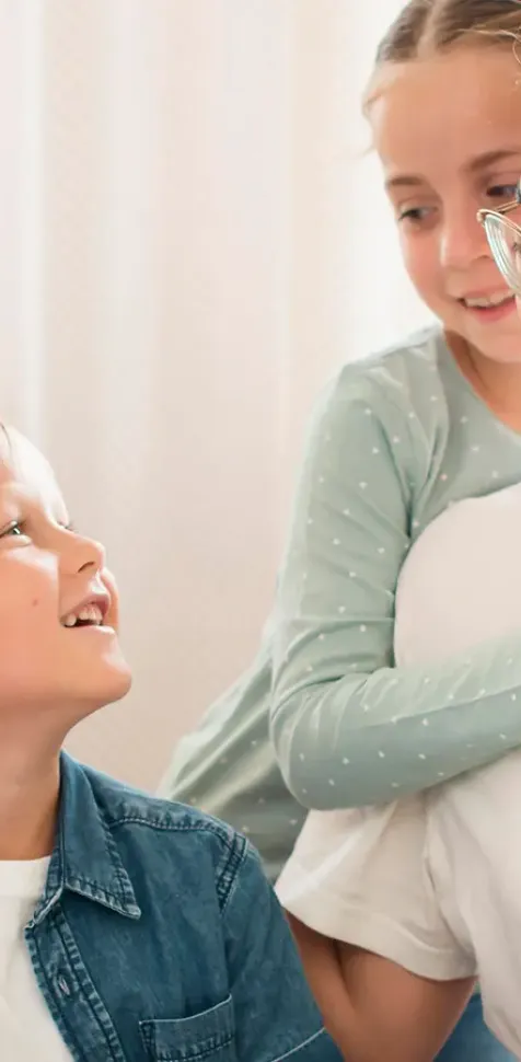 Maestra de Educación Infantil guiando a un grupo de niños mientras juegan y aprenden con cubos apilables, mostrando el enfoque práctico y creativo del grado en Educación Infantil.